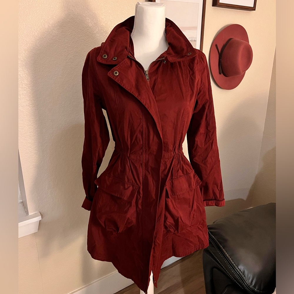 Red light trench coat. Medium, collapsible hood. Pockets, cinch adjustable waist